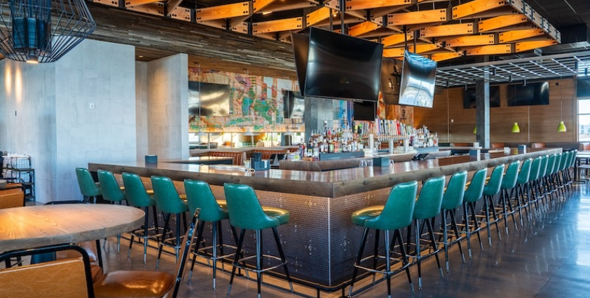Inside bar with bar stools and televisions